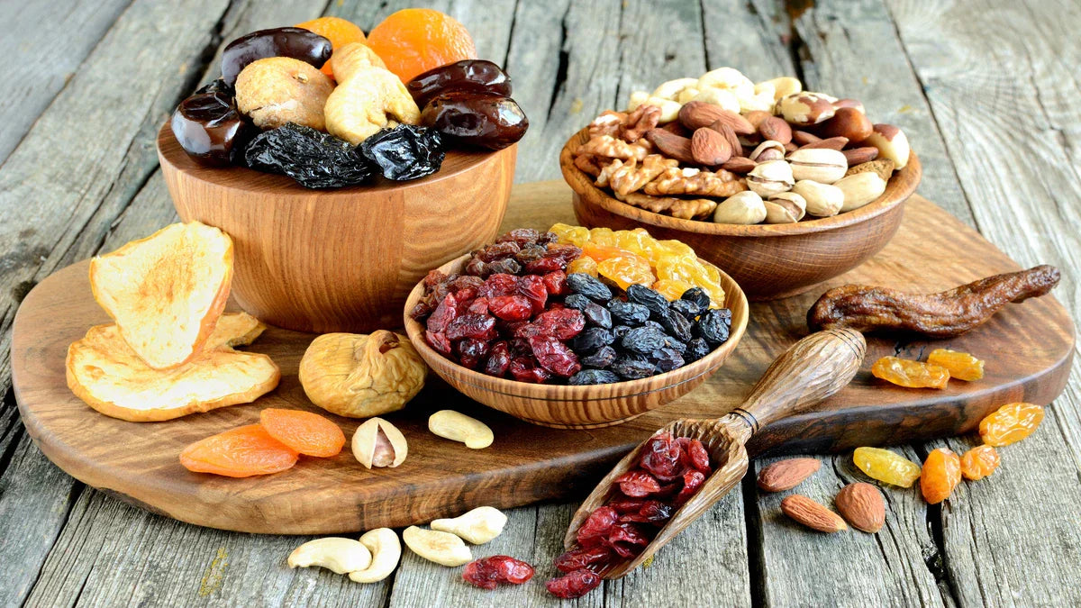 Wooden bowls filled with premium dried fruits and nuts on a rustic board, sourced from quality wholesale suppliers.